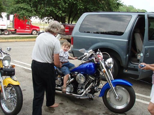 Kid sitting on all the bikes..